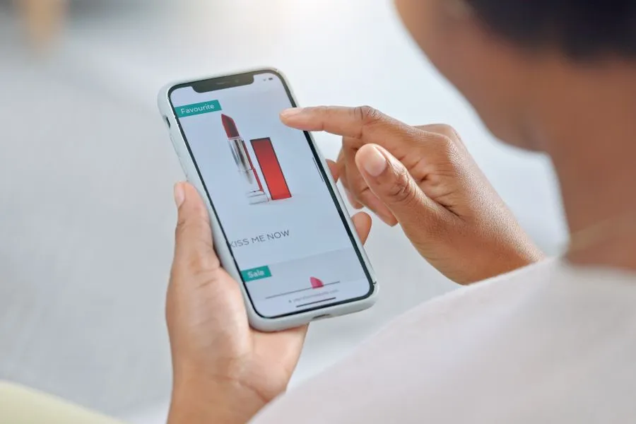 A person buying a lipstick on their phone.